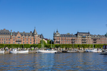 Fototapeta premium Historic waterfront buildings and boats in Stockholm city Sweden