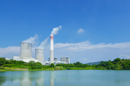 Thermal Power Station with Cooling Towers and Smokestack Reflected in Water