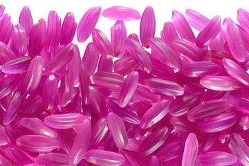 Naklejka premium Pink rice grains spread out on a white surface with clear outlines and smooth texture during daylight