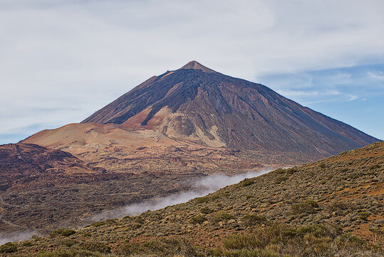 Summit of mount Teide rising above the surrounding shrubland. Tenerife, Canary islands, Spain 