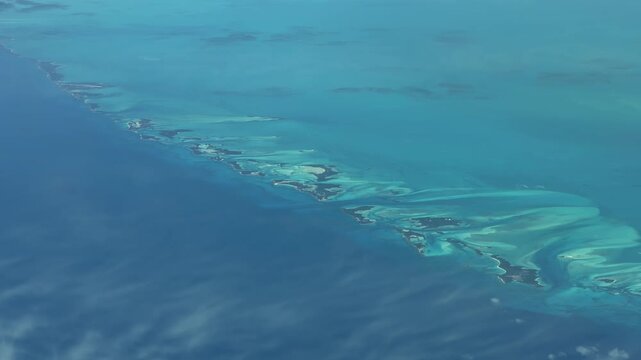 4k aerial video footage flying across turquoise water surface and many small cays near Black Point, Bahamas, located in the Caribbean Sea in Atlantic Ocean