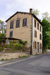 Obraz premium Old abandoned house with boarded windows on quiet street, rustic European architecture