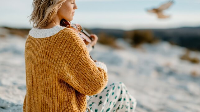 A serene scene of a young woman playing the violin against a stunning natural backdrop, embodying passion for music and connection with nature&rsquo;s beauty.