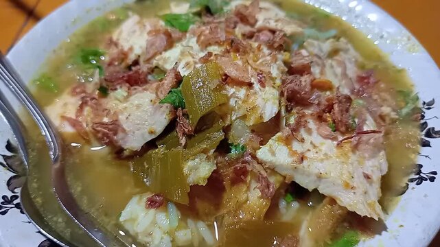 Steaming hot bowl of Indonesian yellow chicken soup, Soto Lamongan