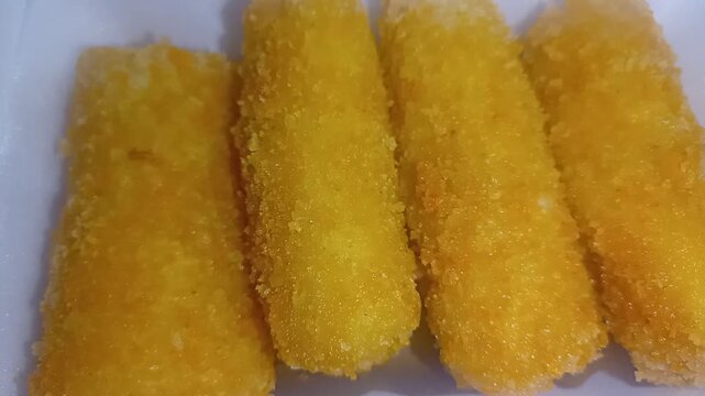 Close-up of crispy fried Indonesian Risoles snack on white background.