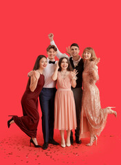 Young people with prom queen on red background © Pixel-Shot