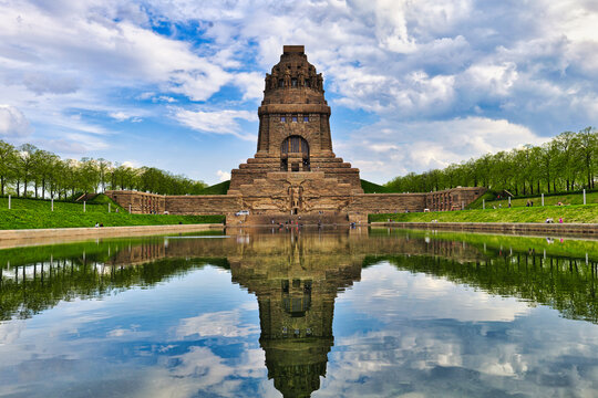 Monument to the Battle of the Nations in Leipzig, Germany, with beautiful water reflection under a dramatic sky  - real photography - authentic - no ai