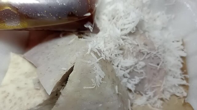 Freshly steamed Kue Putu, traditional Indonesian bamboo rice cake with coconut.