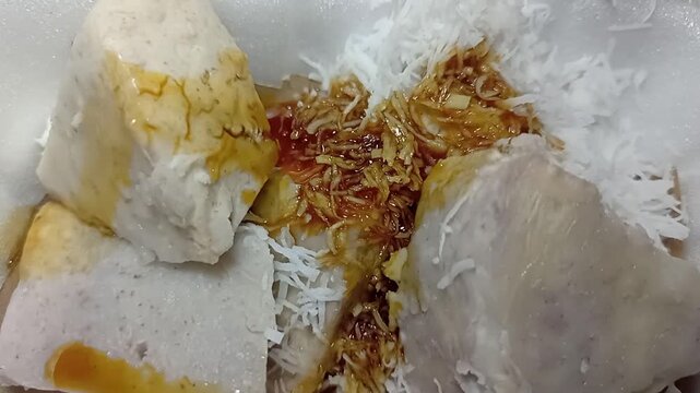 Freshly steamed Kue Putu, traditional Indonesian bamboo rice cake with coconut.