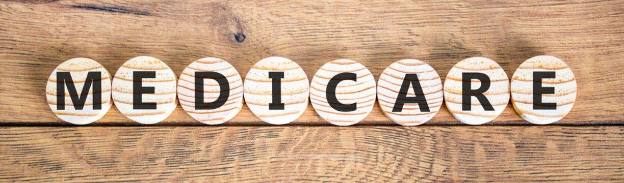 Medicare word symbol. Concept word Medicare on beautiful wooden circles. Beautiful wooden background. Medical support help medicare word concept. Copy space.
