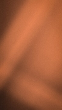 Abstract vertical orange brown and terracotta grainy gradient background with soft blur