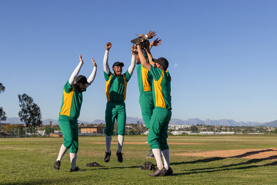 4 baseball players jumping on infield after teammate catching ball with animated stats from glove