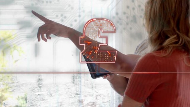 Man showing tablet, pound and circuitry aligning, woman touching tablet to confirm finance choice