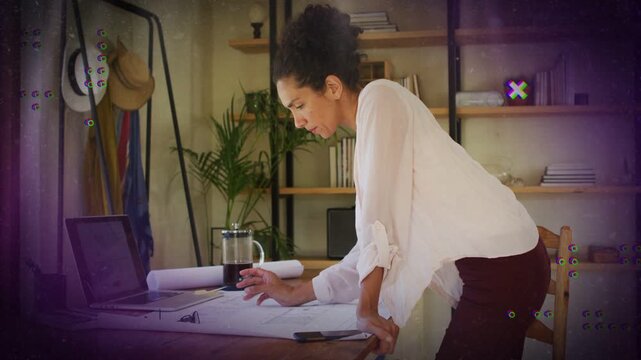 Architect leaning over desk seeing plan error tapping laptop checking plans as motion art passing