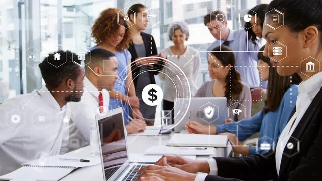 Project team gathering around table typing causing animated HUD aiding budget analysis over laptops