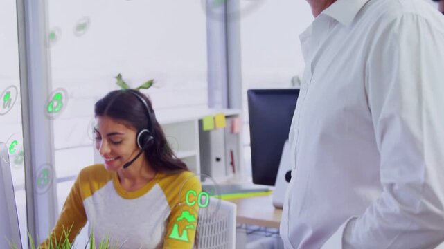 Support agent typing at desktop, green icons floating, manager approaching with tablet consulting