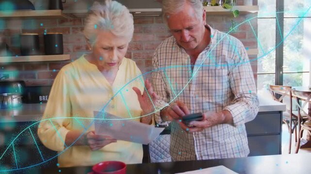 Senior couple reviewing bills in kitchen, man tapping phone revealing animated finance highlights