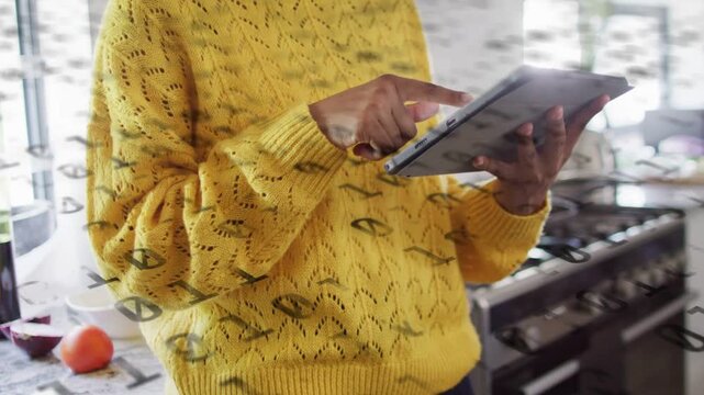 Woman tapping tablet and activating binary overlay while reviewing tech data near fruit and glass