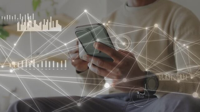 Man tapping phone on couch, initiating data overlays and charts, monitoring tech while sipping mug