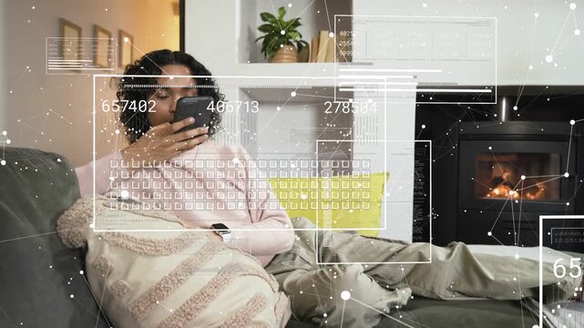Non-binary person reclining on couch, tapping smartphone and causing animated AR data HUDs to shift