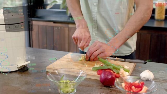 Home cook placing green vegetable then chopping on cutting board with chef knife, prepping meal