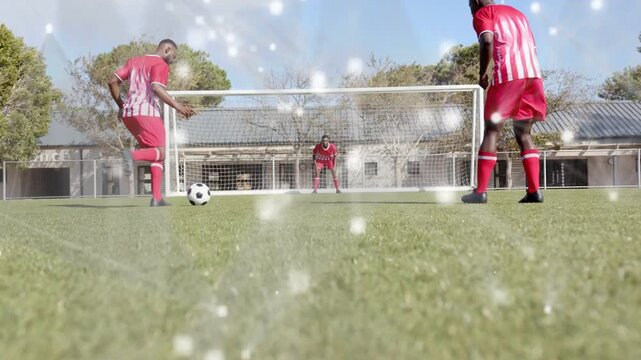 Ball rolling left player receiving and shooting toward goal in sports drill GK diving amid sparkle