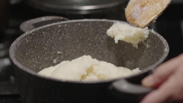 Cooking ghomi, a popular dish from the Samegrelo region made with coarse white corn flour
