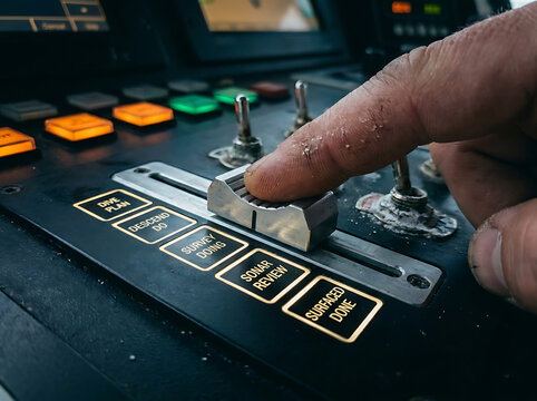 Close-up of a worker's finger precisely adjusting a crucial fader on a sophisticated, illuminated control panel, highlighting operational control in a high-tech environment