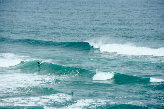 Surfer or bodyboarder in the big waves of Cantabria in Spain.