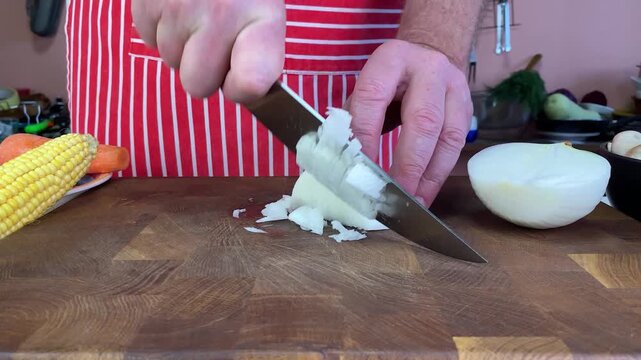 Home Cooking And Healthy Eating, Man Chopping Onion On Wooden Board With Fresh Vegetables In Kitchen.