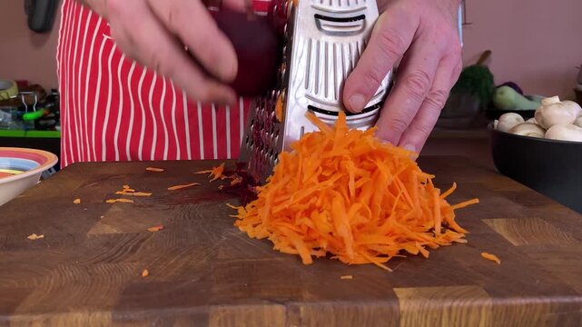 Person grating beetroot for cooking, preparing fresh vegetables on a cutting board, healthy meal preparation.