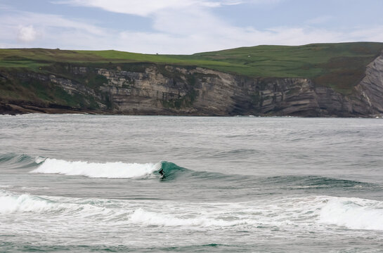 Surfer or bodyboarder in the big waves of Cantabria in Spain.