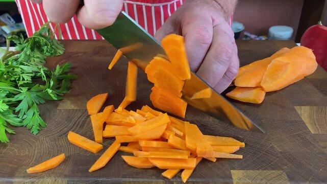 Persons hands using a peeler to remove skin from an orange carrot, preparing a vegetable for cooking or a healthy meal.