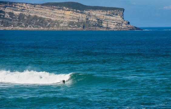 Surfer or bodyboarder in the big waves of Cantabria in Spain.