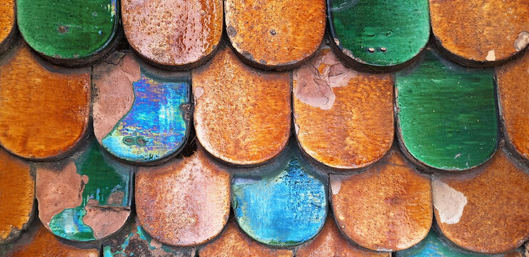 Panorama of orange and green roof tiles.