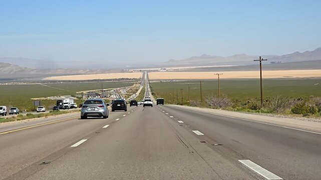 Highway Traffic Across Mojave Desert Between Los Angeles And Las Vegas, cinematic road trip video frame with cars and distant mountains