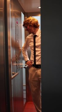 Vertical screen office worker in elevator prepares for difficult meeting tense focused expression shows pressure anxiety and anticipation before important negotiation or serious workplace discussion