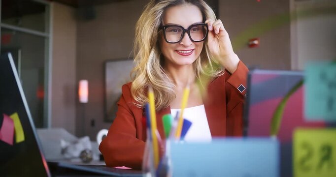 Smiling Businesswoman Working at Desk in Office