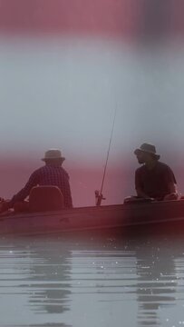 Vertical video: Left man adjusting rear gear to maintain drift, making right man look, fishing rods