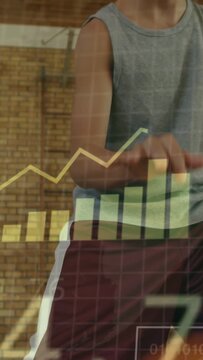 Vertical video: Student athlete practicing dribbling in gym, showing data overlays COLLECTING DATA