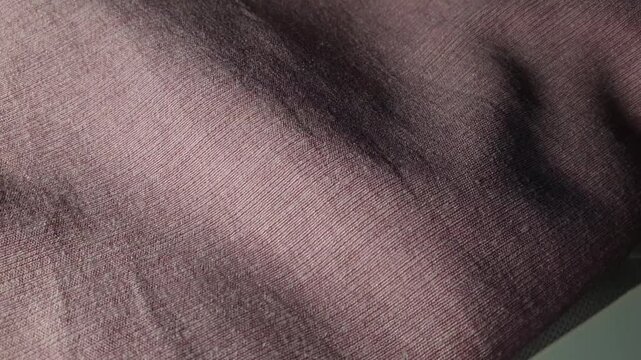 Burgundy textured fabric fold, soft upholstery cloth for clothing and home decor, close up material texture