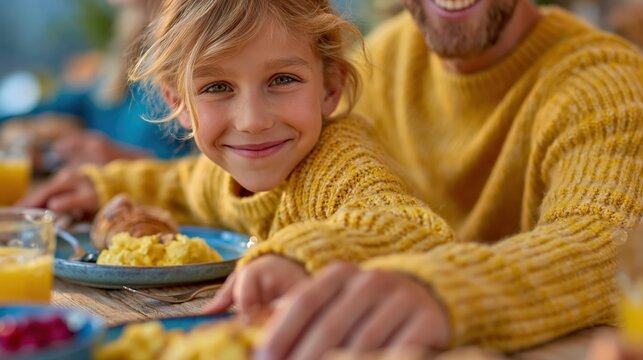 A joyful scene of a family breakfast where a smiling child is seated next to an adult, sharing delicious food and a warm connection, showcasing love and togetherness.