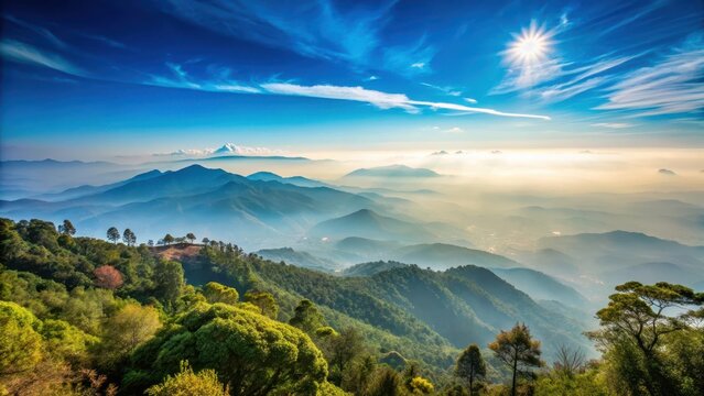 A photo of misty mountains in the distance with a vast blue sky above, captured at Yercaud hill station