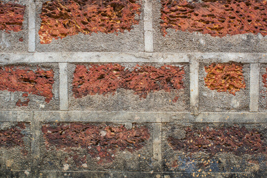 Red Laterite Stone Wall Texture with Cement Lines Background