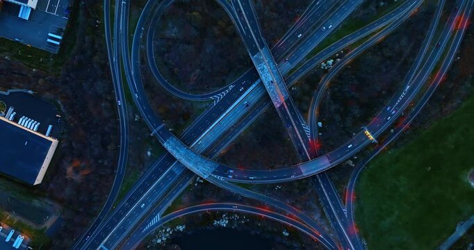 Rising over the interchange with roads, loops and trestles. Woods grow around the lively intersection.