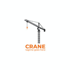A construction crane stands tall in an industrial area with a hook. © womaura