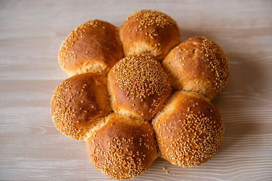Challah bread rolls with sesame seeds, traditional Jewish food baked at Greek bakery on Ikaria island, Greece macro closeup