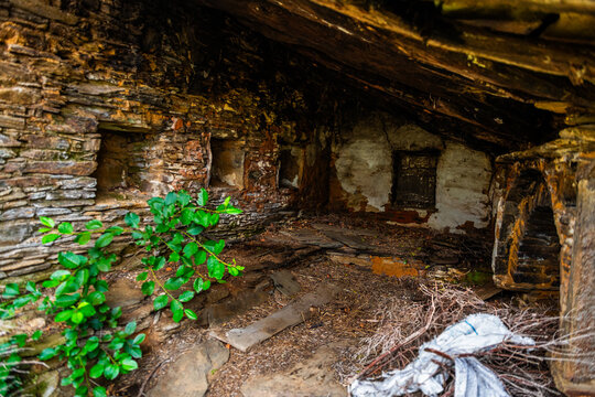 Karavostamo in Ikaria island, Greece abandoned mountain village stone home house interior with window fireplace at old ancient town