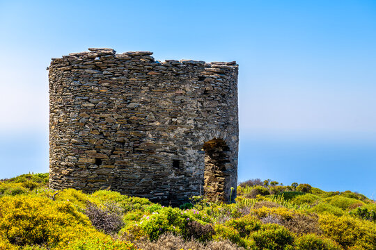 Watchtower tower ruins at Perdiki village on Ikaria island, Greece cityscape of small town with houses at longevity blue zone