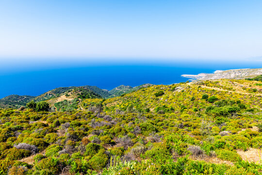Perdiki village view on Ikaria island northern shore coast, Greece with Faros airport runway and landscape nature view